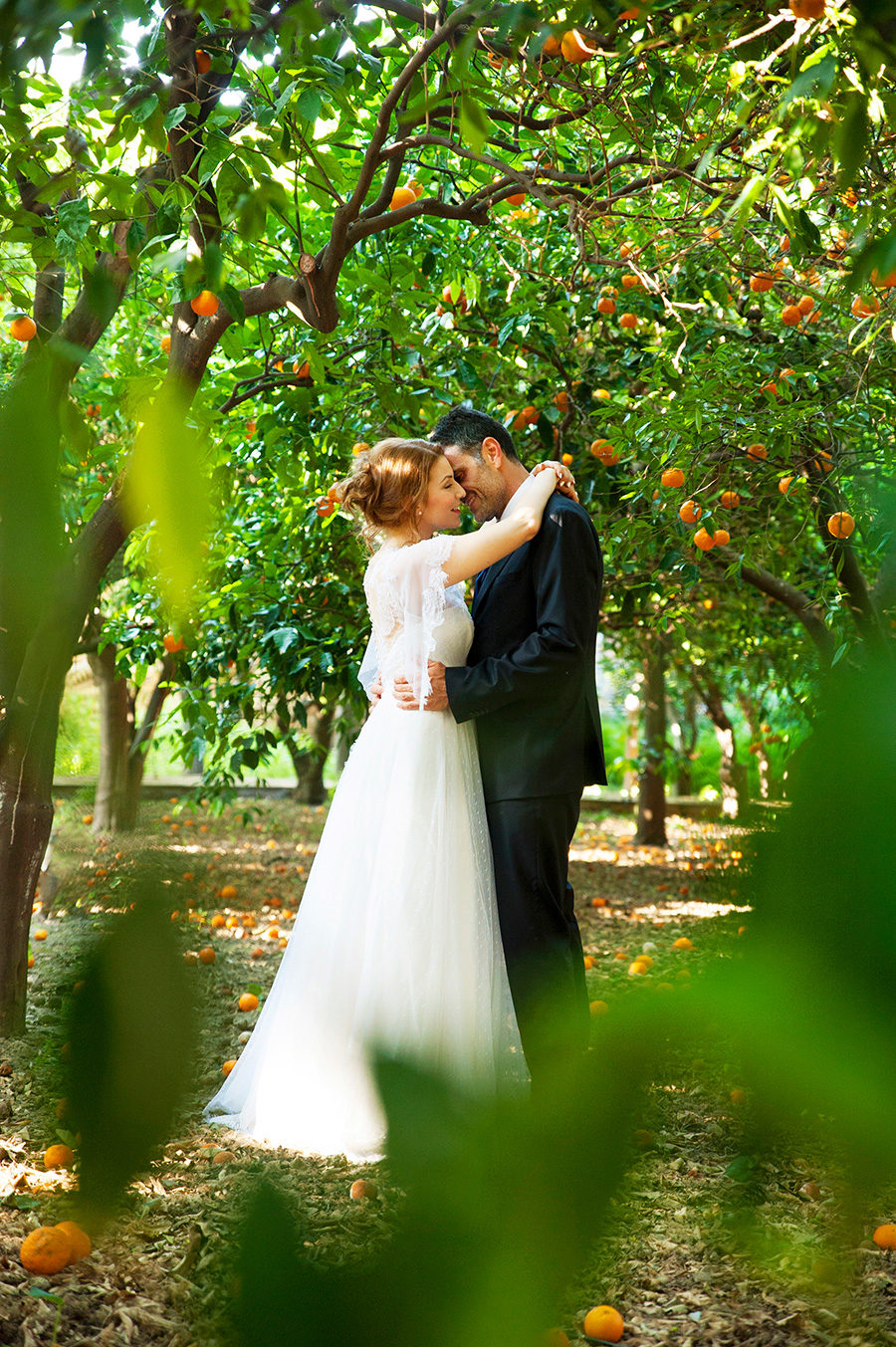 Play with the oranges. Kampos. Wedding Photoshooting. orange trees. Bride's and Groom's portrait. Riziko. greek wedding . Chios , Greece. greek island. Couple photoshooting. Love and married. Alepa Katerina . Layer Photography