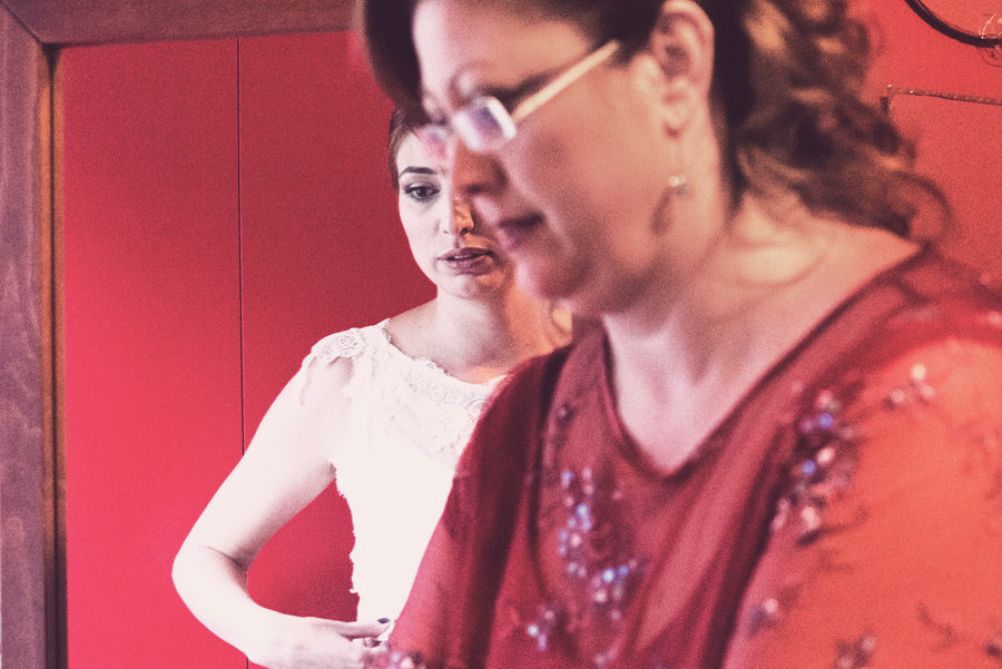 Bride's preparation. Close up picture. Bride's mother helps hair with the wedding belt. wedding dress.vintage Bride. mirror. red. Civil wedding in Thessaloniki, Greece