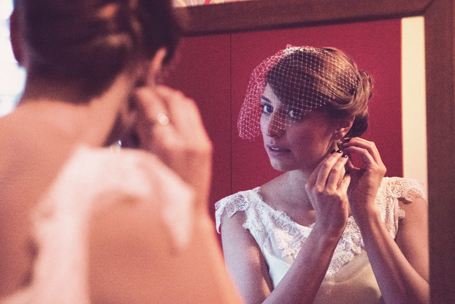 Bride's preparation. Bride wearing the earrings. small diamonds. vintage Bride.mirror. Civil wedding in Thessaloniki, Greece. Layer Photography. Alepa Katerina