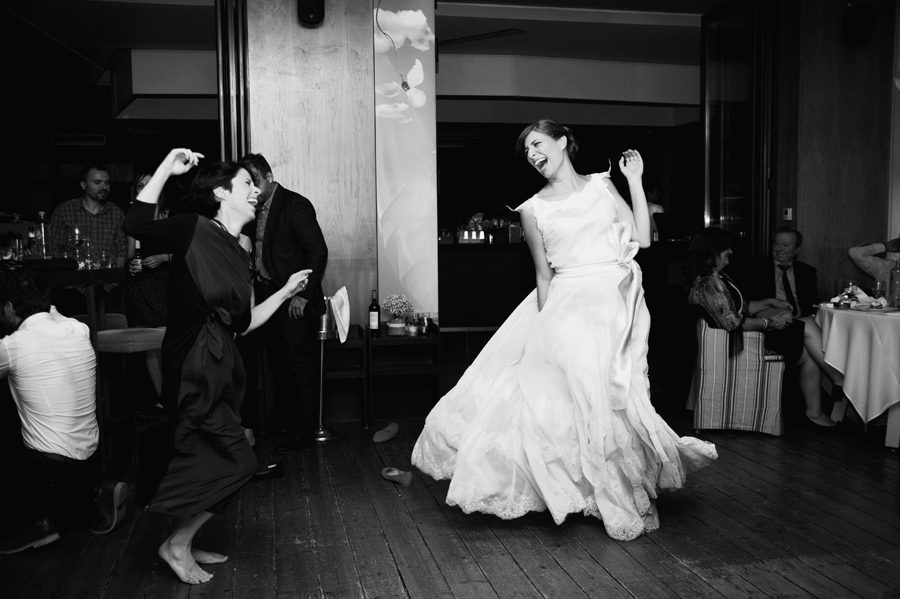 The bride is dancing with her best friend in the wedding party.Civil wedding in Thessaloniki,Greece